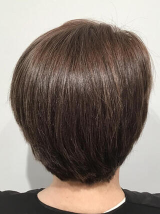 After photo: rear view of woman with short brunette hair with no grey after colour.