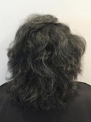 Before Photo: rear view of woman with short black hair with a lot of grey before colour.