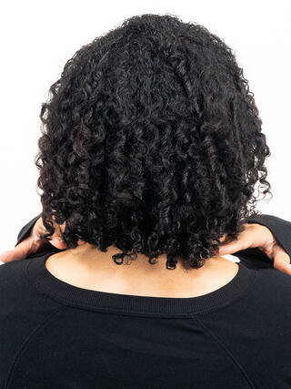 After photo: rear view of woman with short black hair with even colour throughout.